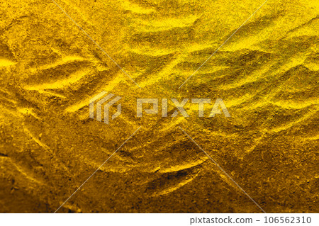 Golden texture with rough unevenness and wavy pattern reminiscent of ancient treasures 106562310