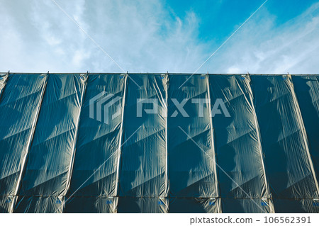 Building under repair work Sunlight shining on the protective curtain b-5 Film style Building under repair work Sunlight shining on the protective curtain b-5 Film style 106562391