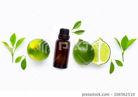 Limes with essential oil isolated on white background. Limes with essential oil isolated on white background. 106562510