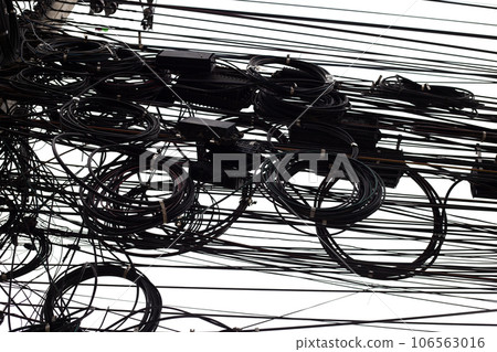 Many electrical cable are tangled on an electric pole. Many electrical cable are tangled on an electric pole. 106563016