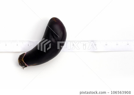 Eggplant with measuring tape on white background. Eggplant with measuring tape on white background. 106563908