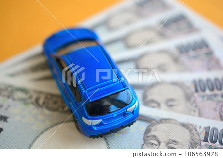 A blue minicar on top of the 10,000 yen bill A blue minicar on top of the 10,000 yen bill 106563978