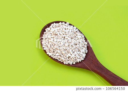 Barley grain on green background. Barley grain on green background. 106564150
