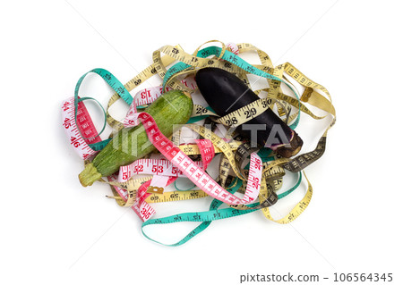 Zucchini and eggplant with measuring tape on white background 106564345