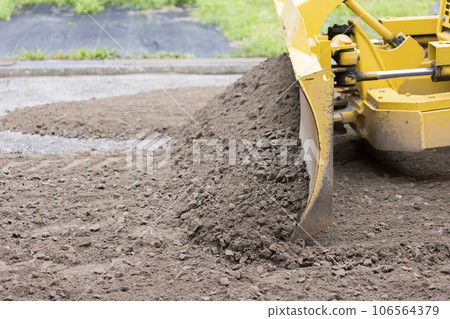 Paving work image: Bulldozer leveling the roadbed Paving work image: Bulldozer leveling the roadbed 106564379