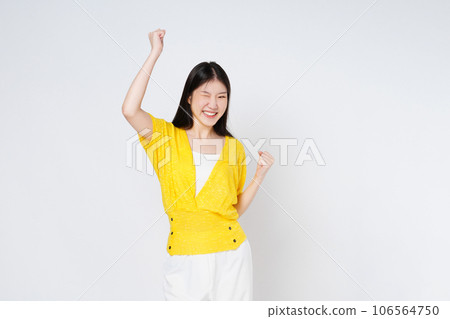 Young asian woman with raised hands celebrating success isolated on white background. Young asian woman with raised hands celebrating success isolated on white background. 106564750