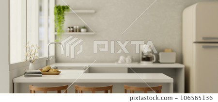 Copy space on a white kitchen countertop in a modern white kitchen interior with kitchen appliances. Copy space on a white kitchen countertop in a modern white kitchen interior with kitchen appliances. 106565136