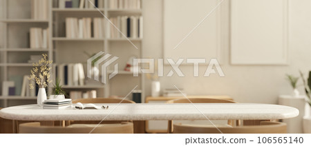 Empty space on a table in a cozy Scandinavian white living room with a bookshelf in the background. 106565140