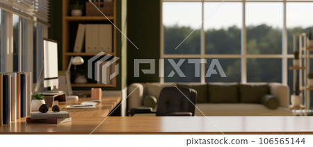 Copy space on a wooden desk in a modern cozy home working room or office. Copy space on a wooden desk in a modern cozy home working room or office. 106565144