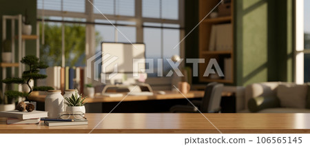 Empty space on a wooden table in a modern home office room with a computer desk against the window Empty space on a wooden table in a modern home office room with a computer desk against the window 106565145