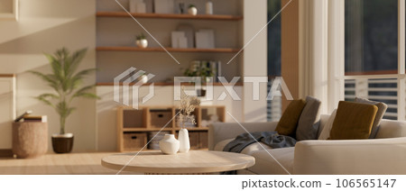 A minimal wooden coffee table with ceramic vases in a cozy Scandinavian living room interior style. 106565147
