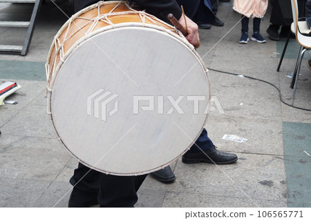 A man hit the ancient drum with Musical Instrument. 106565771