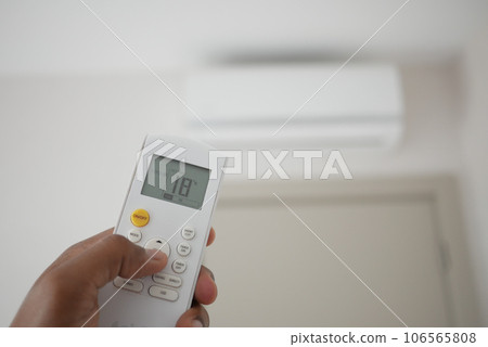 Close up of man hand holding air condition remote. 106565808