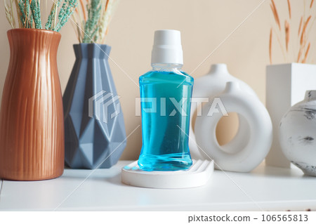 mouthwash liquid in a container on table mouthwash liquid in a container on table 106565813