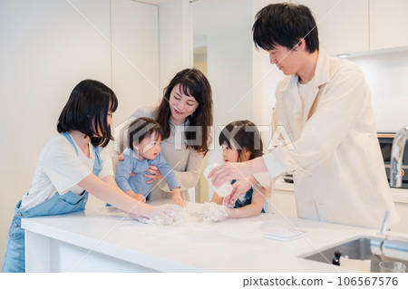 Parents and children cooking together at home 106567576