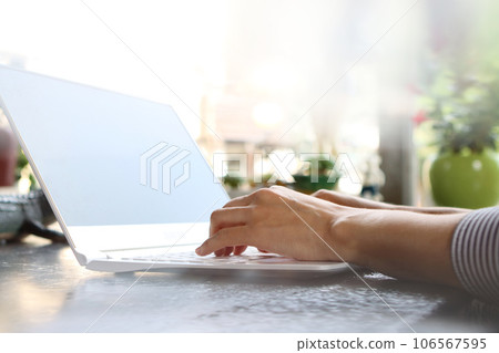 Modern office worker woman smiling brightly at home or office and working from home via internet online on laptop Modern office worker woman smiling brightly at home or office and working from home via internet online on laptop 106567595