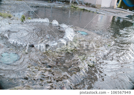 Flood damage Manhole overflowing with water 106567949
