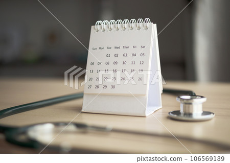 Stethoscope with calendar page date on wood table background doctor appointment medical concept 106569189