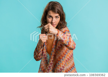 Aggressive young woman trying to fight at camera, shaking fist, boxing with expression, punishment 106569362
