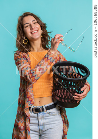 Woman taking off, throwing out glasses into bin after medical vision laser treatment therapy surgery 106569389