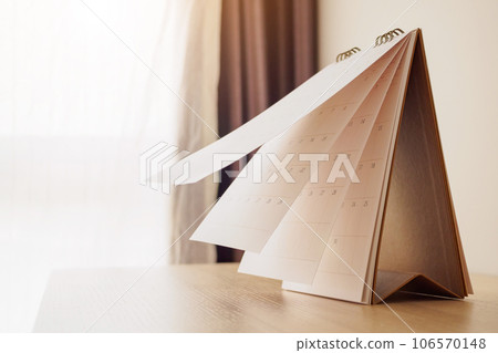 Calendar page flipping sheet on wood table background business schedule planning appointment meeting concept 106570148