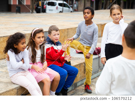 Happy tween boys and girls gathering outdoors on autumn day 106570212