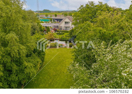 an aerial view of the house from above, with trees and bushes in the fore - image is taken from drone an aerial view of the house from above, with trees and bushes in the fore - image is taken from drone 106570282
