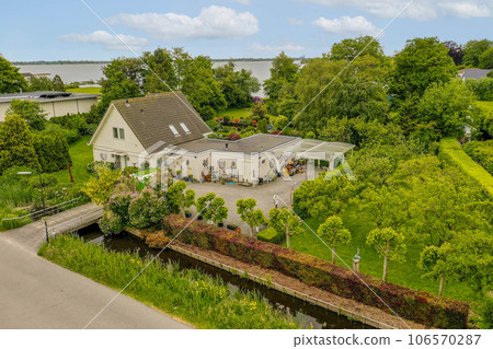 an aerial view of the house and garden from above it, with some trees in the foreground is visible on the right side an aerial view of the house and garden from above it, with some trees in the foreground is visible on the right side 106570287