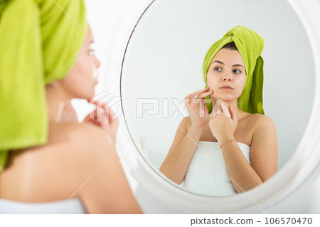 Portrait of young pretty girl in bath towel on her head Portrait of young pretty girl in bath towel on her head 106570470