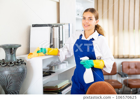 Charwoman cleaning office 106570625