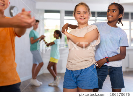 African boy and European girlie learn figures of pair jive dance and train before competition 106570676