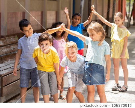 Energetic children play a game called trickle on the street Energetic children play a game called trickle on the street 106570915