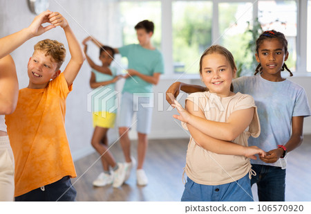 African boy and European girlie learn figures of pair jive dance and train before competition African boy and European girlie learn figures of pair jive dance and train before competition 106570920