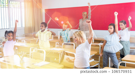 Kids pupils having physical training between lessons 106570931