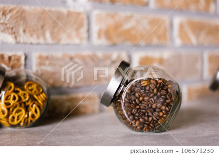 Roasted coffee beans in a glass jar in the kitchen Roasted coffee beans in a glass jar in the kitchen 106571230
