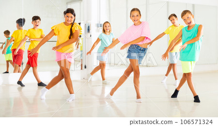 Group of kids training modern dance moves Group of kids training modern dance moves 106571324