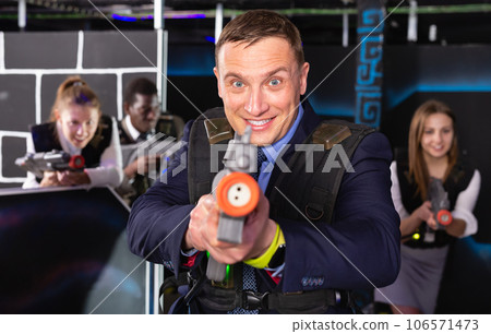 Man holding laser gun and playing laser tag Man holding laser gun and playing laser tag 106571473