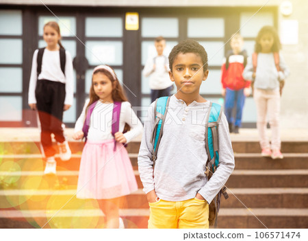 Tween african boy walking to school campus after lessons Tween african boy walking to school campus after lessons 106571474