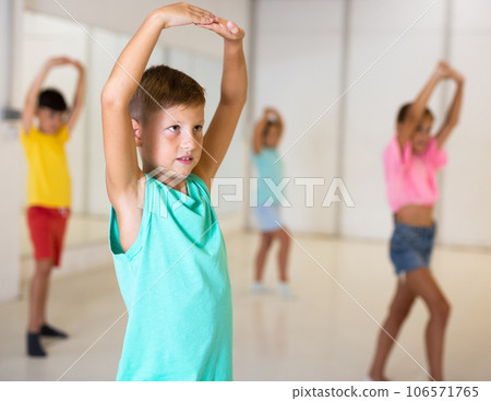 Young girls and boys performing modern dance in studio Young girls and boys performing modern dance in studio 106571765