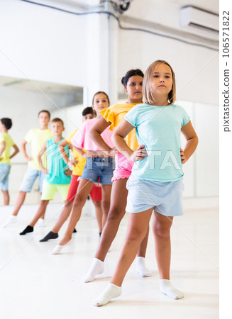 Tween girl with children standing in row one by one in choreography class 106571822
