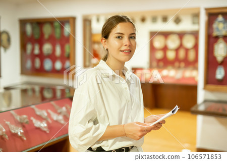 Positive woman in hall of historical museum Positive woman in hall of historical museum 106571853