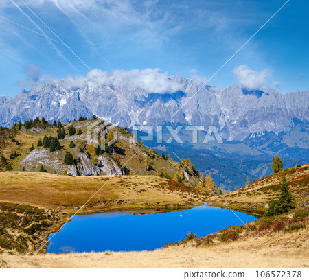 Autumn alpine Kleiner Paarsee or Paarseen lake, Land Salzburg, Austria. Alps Hochkonig rocky mountain group view in far. Autumn alpine Kleiner Paarsee or Paarseen lake, Land Salzburg, Austria. Alps Hochkonig rocky mountain group view in far. 106572378