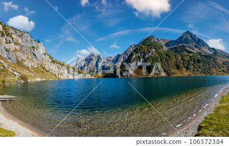 Sunny autumn alpine Tappenkarsee lake and rocky mountains above, Kleinarl, Land Salzburg, Austria. Sunny autumn alpine Tappenkarsee lake and rocky mountains above, Kleinarl, Land Salzburg, Austria. 106572384
