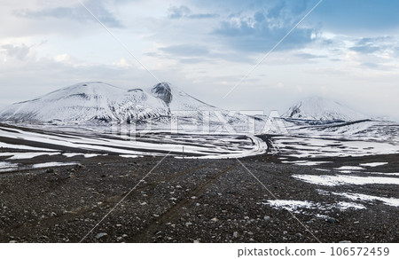 Colorful Landmannalaugar mountains under snow cover in autumn, Iceland. Lava fields of volcanic sand in the foreground. Colorful Landmannalaugar mountains under snow cover in autumn, Iceland. Lava fields of volcanic sand in the foreground. 106572459