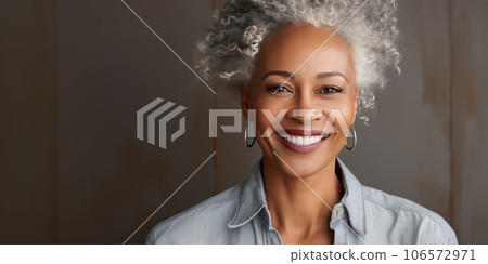 Middle-aged woman with a short gray hair looking at camera. 106572971