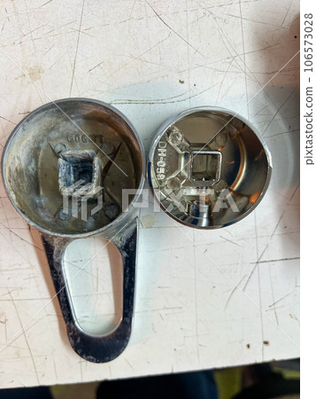 two handles for the tap lie on the table 106573028