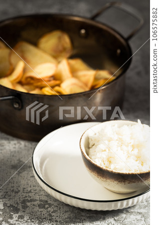 Rice and fried potato slices under the sunlight. 106575882