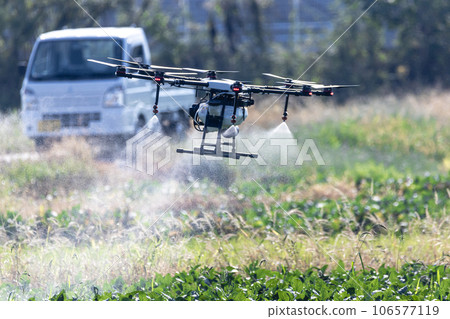 Drone spraying pesticides Drone spraying pesticides 106577119