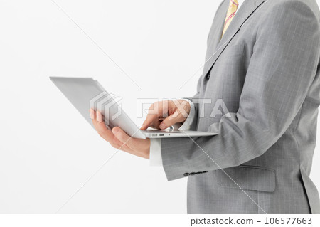 Businessman with a computer in hand Businessman with a computer in hand 106577663