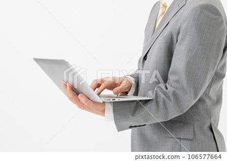 Businessman with a computer in hand Businessman with a computer in hand 106577664